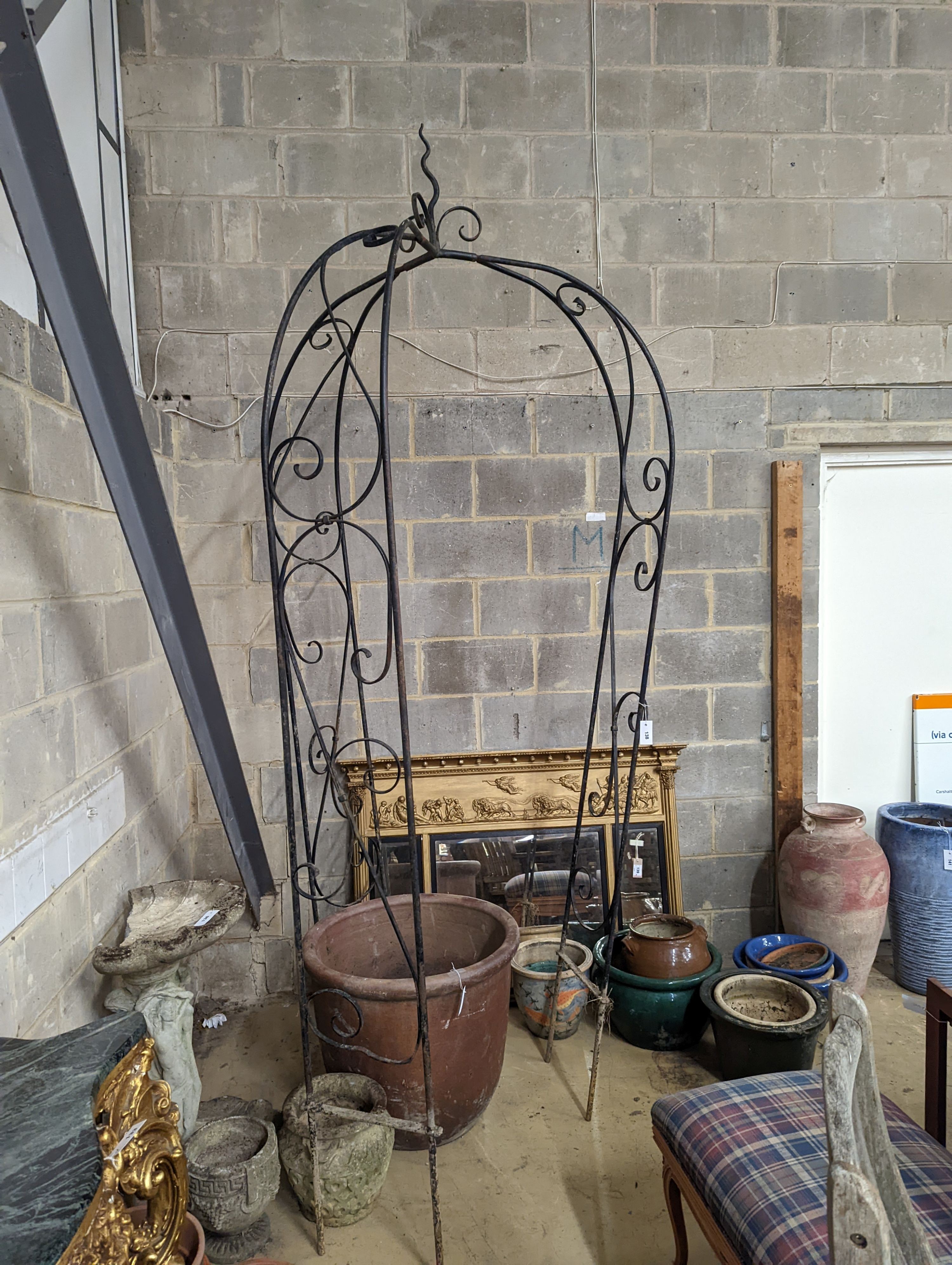 A wrought iron garden arbour, height approx. 250cm